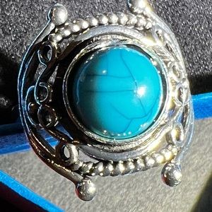 Silver ring with turquoise stone.